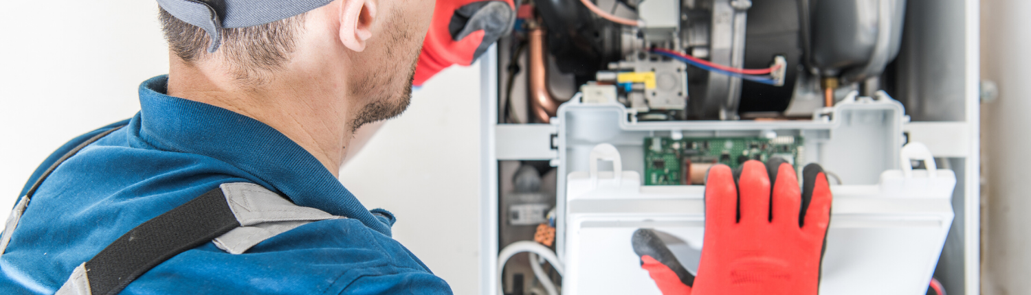 HVAC Technician Looking Inside a Furnace - Comfort A/C